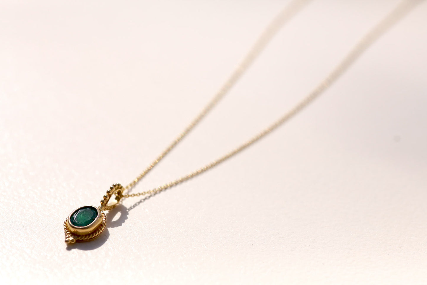 Golden Pendant with Emerald Stone